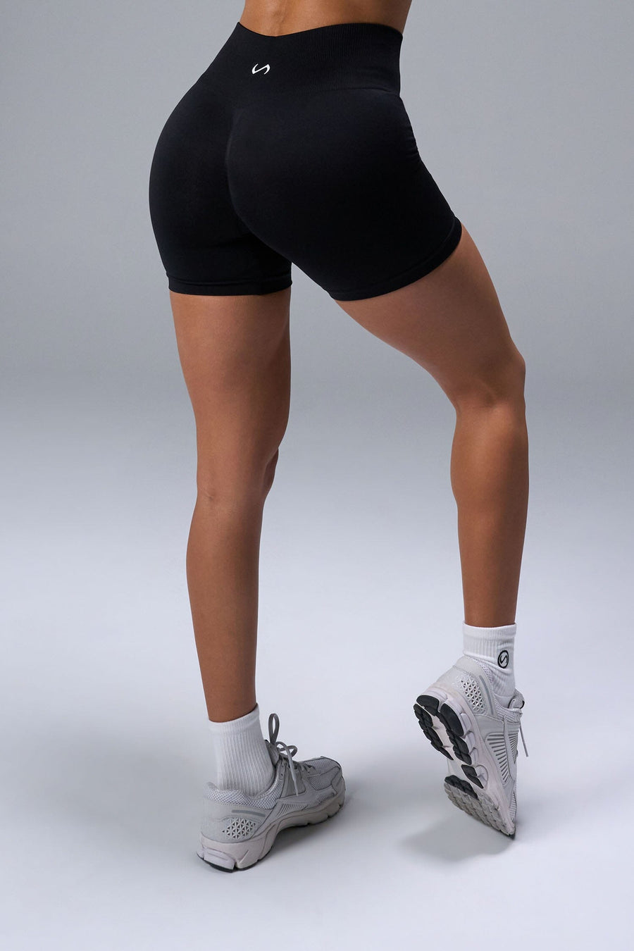 Back View of Black TLF Cosmic Seamless Scrunch Butt Shorts, featuring a scrunch butt to shape and contour your glutes