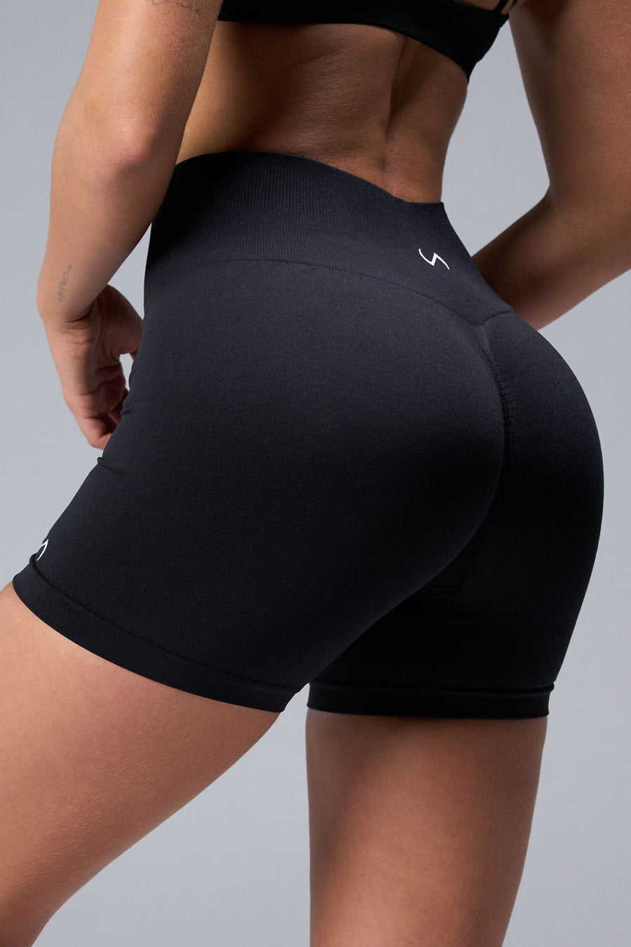 Back View of Black TLF Cosmic Seamless Scrunch Butt Shorts, featuring a scrunch butt to shape and contour your glutes