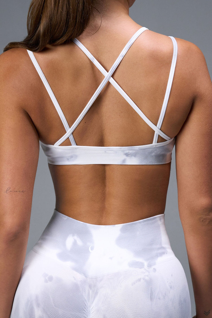 Back View of White TLF Cosmic Seamless Strappy Sports, featuring medium impact support and a strappy back design