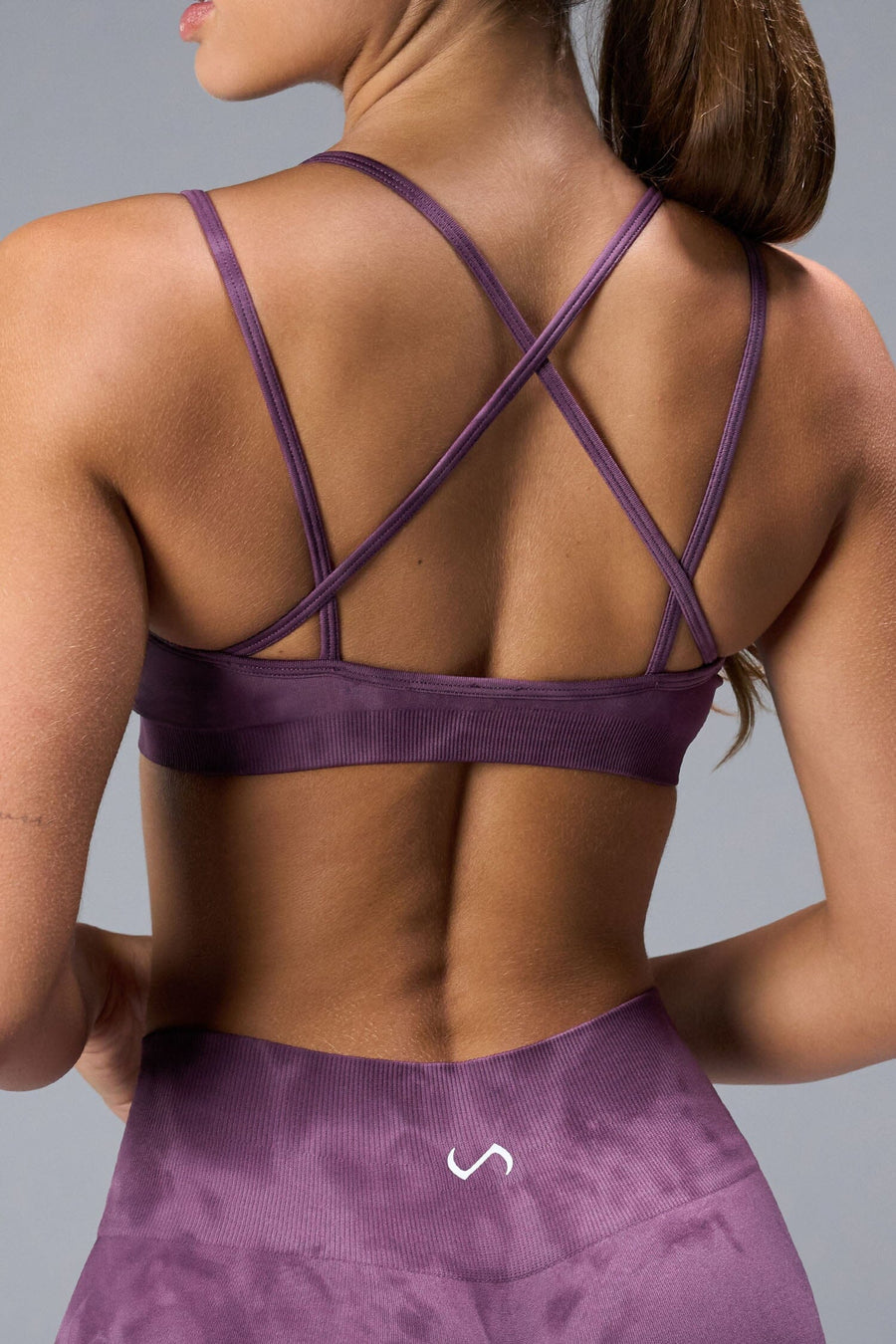 Back View of Purple TLF Cosmic Seamless Strappy Sports, featuring medium impact support and a strappy back design