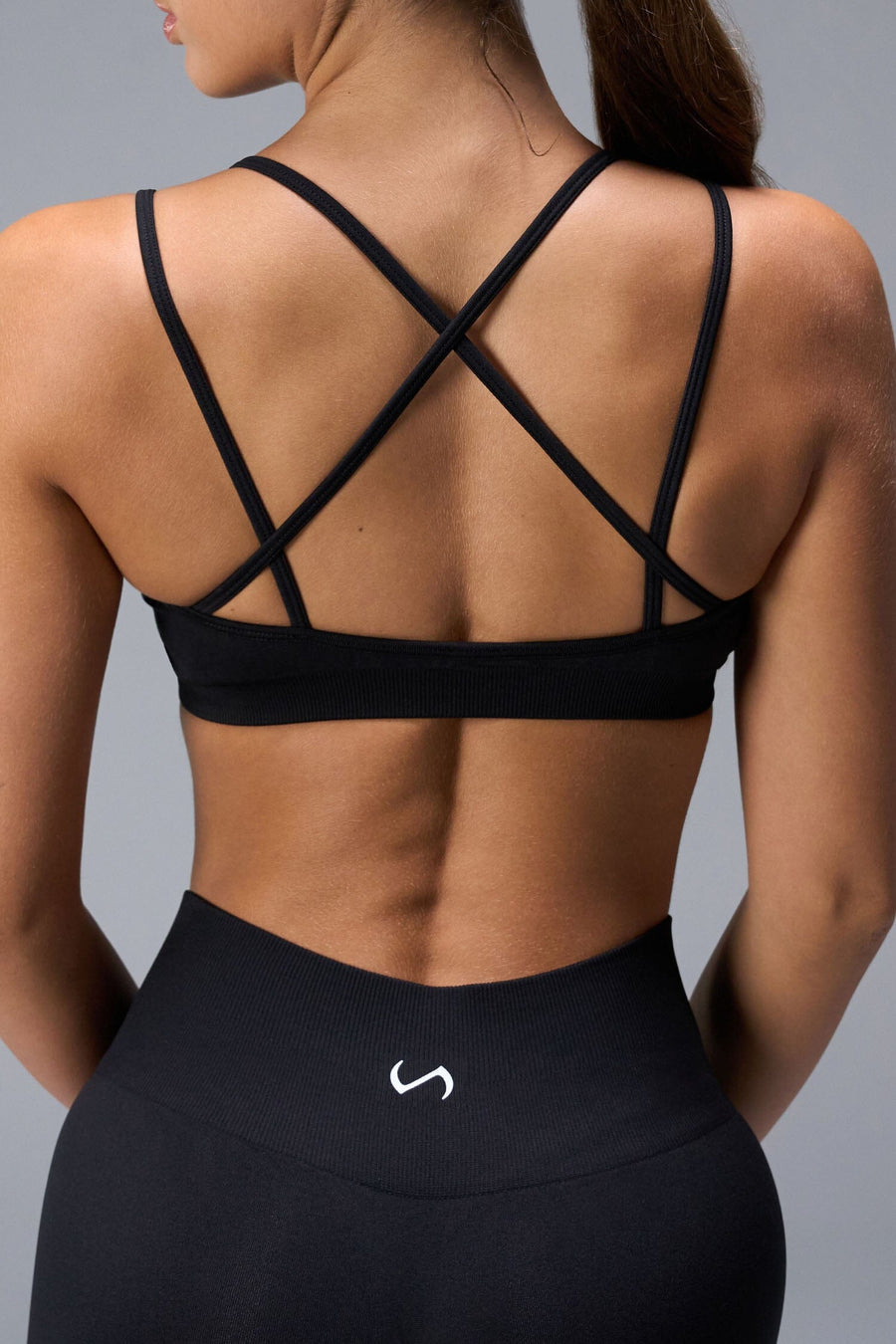 Back View of Black TLF Cosmic Seamless Strappy Sports, featuring medium impact support and a strappy back design