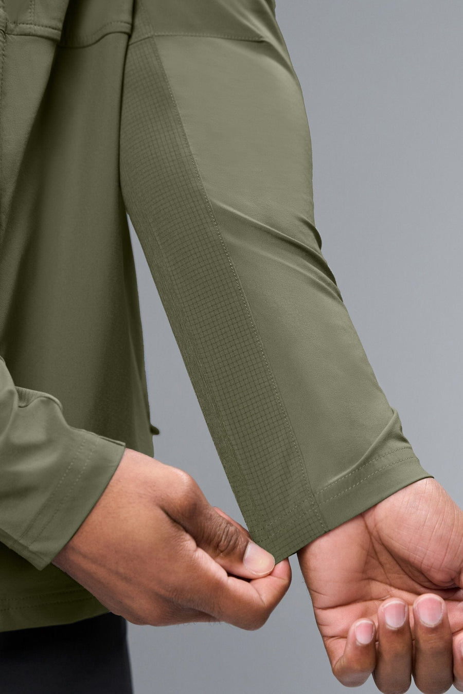 Detail Sleeve View of Green TLF Element Athletic Jacket, featuring multiple zipper pockets, and ripstop panels for breathability and stretch