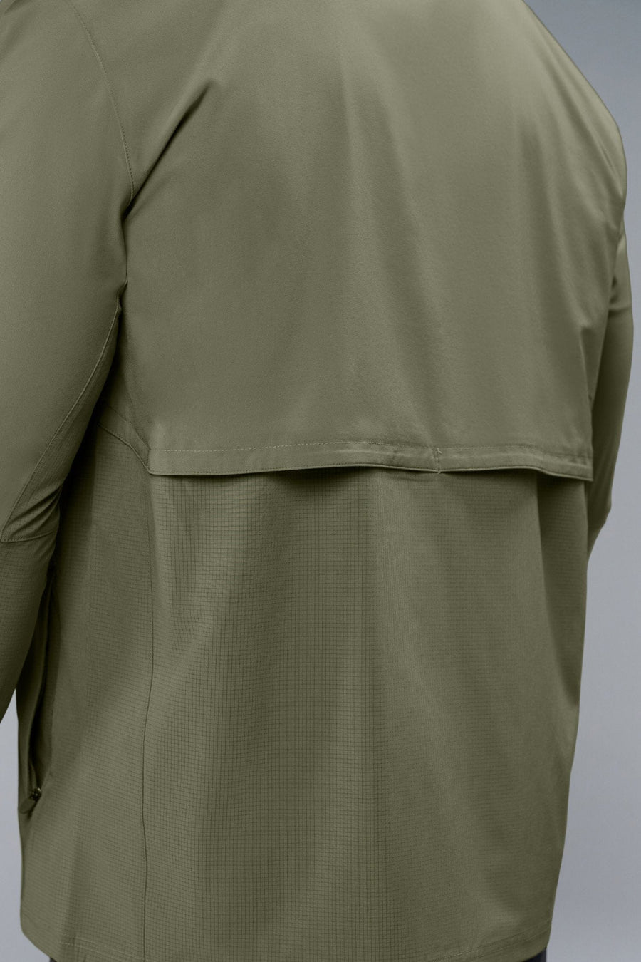 Back View of Green TLF Element Athletic Jacket, featuring multiple zipper pockets, and ripstop panels for breathability and stretch