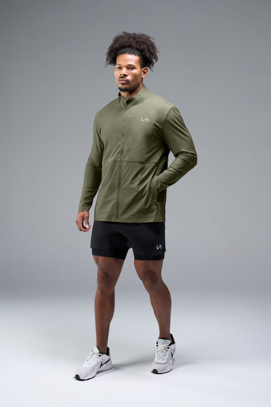 Front View of Green TLF Element Athletic Jacket, featuring multiple zipper pockets, and ripstop panels for breathability and stretch