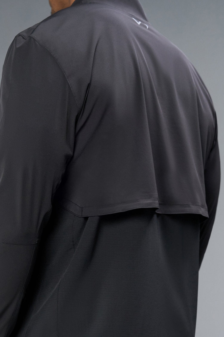 Back View of Black TLF Element Athletic Jacket, featuring multiple zipper pockets, and ripstop panels for breathability and stretch