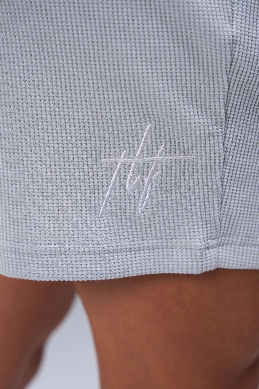 Detail Front View of Gray TLF Elevate Waffle Tech Shorts, featuring a 6” Inch inseam, an athletic relaxed fit with zipper pockets designed for all day wear