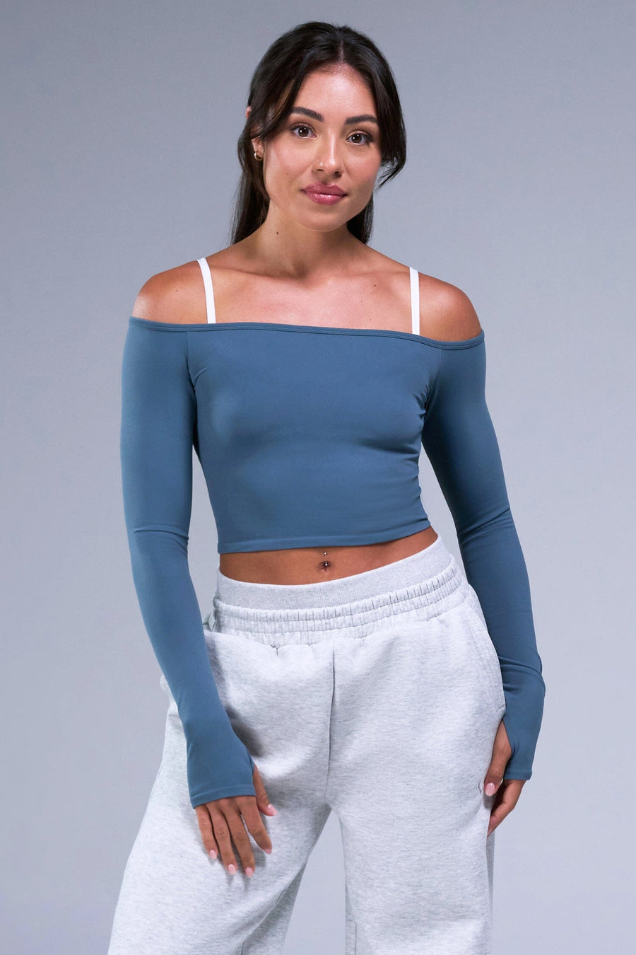 Front View of White TLF Essential Scrunch Seamless Bralette wearing under the Essential Seamless Off The Shoulder Top, featuring adjustable straps for a custom fit and scrunch front design