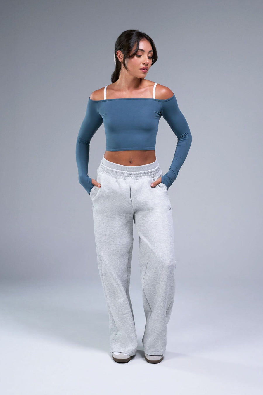 Front View of Blue TLF Essential Seamless off the shoulder top, featuring a cropped length and thumbholes