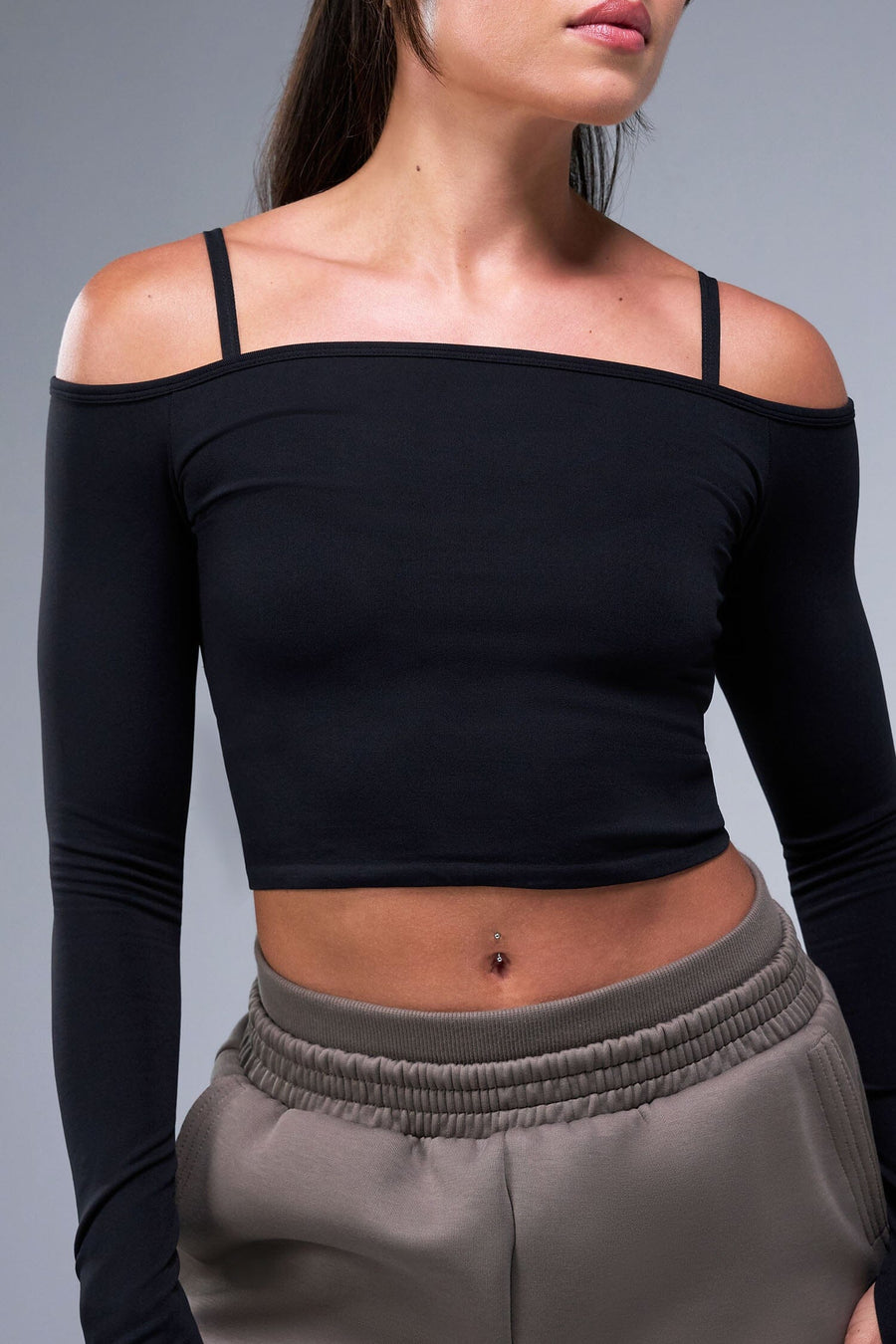 Front View of Black TLF Essential Seamless off the shoulder top, featuring a cropped length and thumbholes