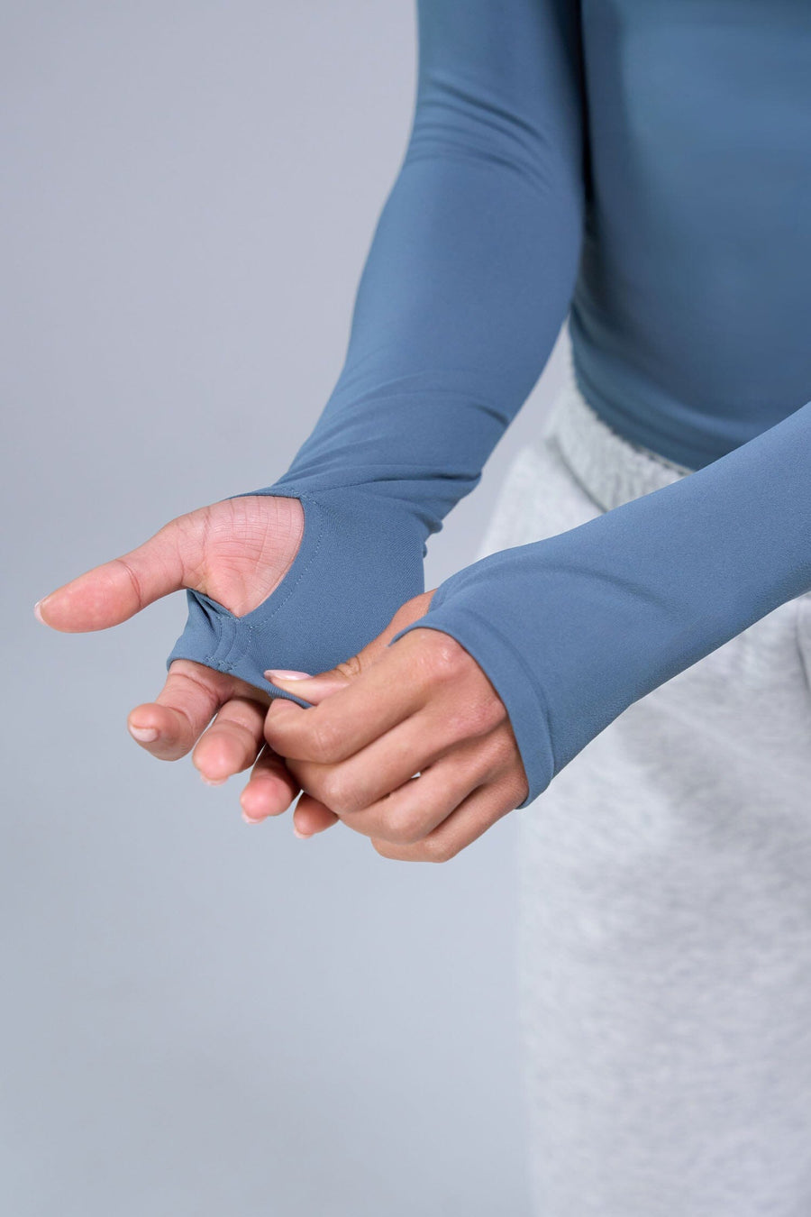 Detail Sleeves View of Blue TLF Essential Seamless Reversible Scoop Neck, featuring thumbholes and multi wear for boat neck or scoop neck styling