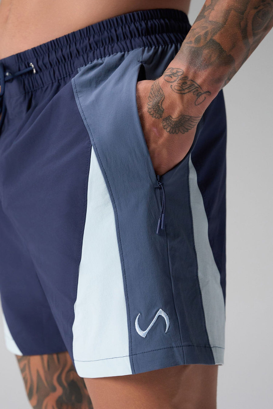 Front View of Blue the TLF GTS Element-Max Shorts featuring contrast color panels and sleek invisible side zipper pockets