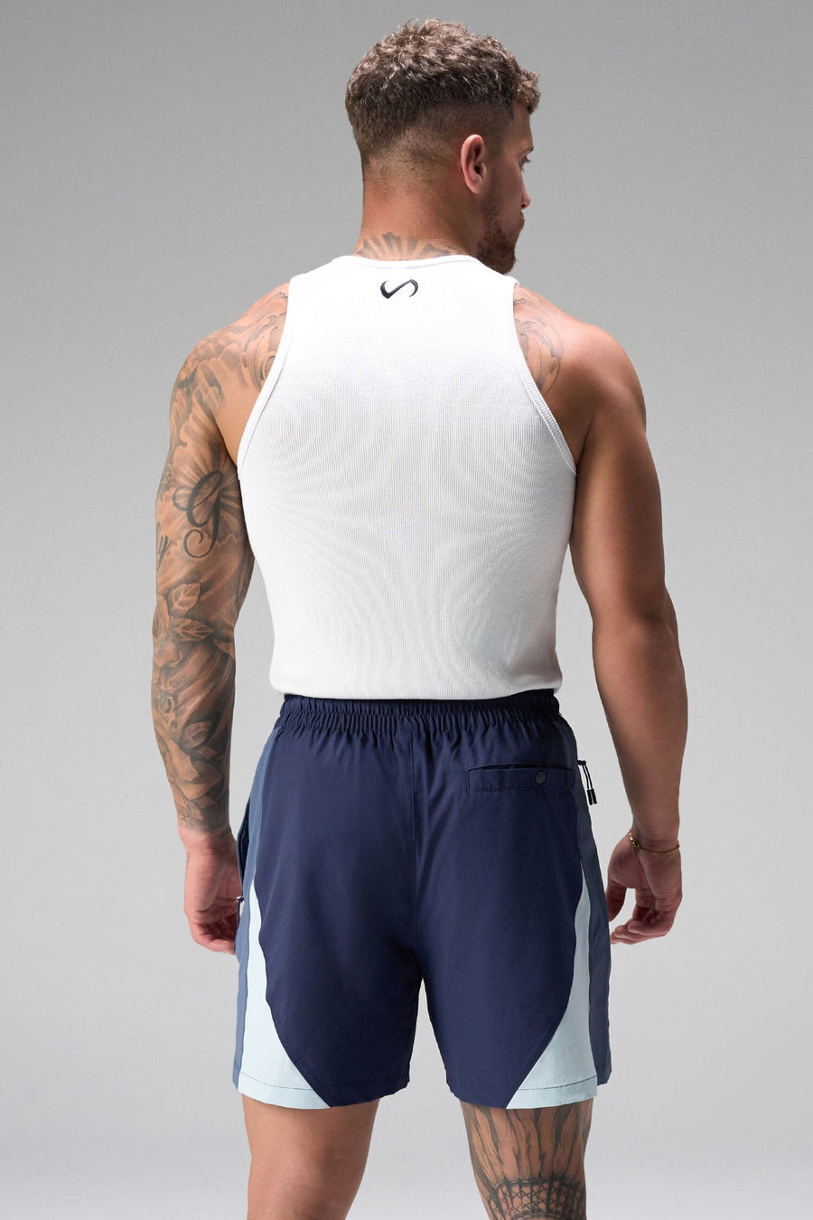Back View of Blue the TLF GTS Element-Max Shorts featuring contrast color panels and sleek invisible side zipper pockets