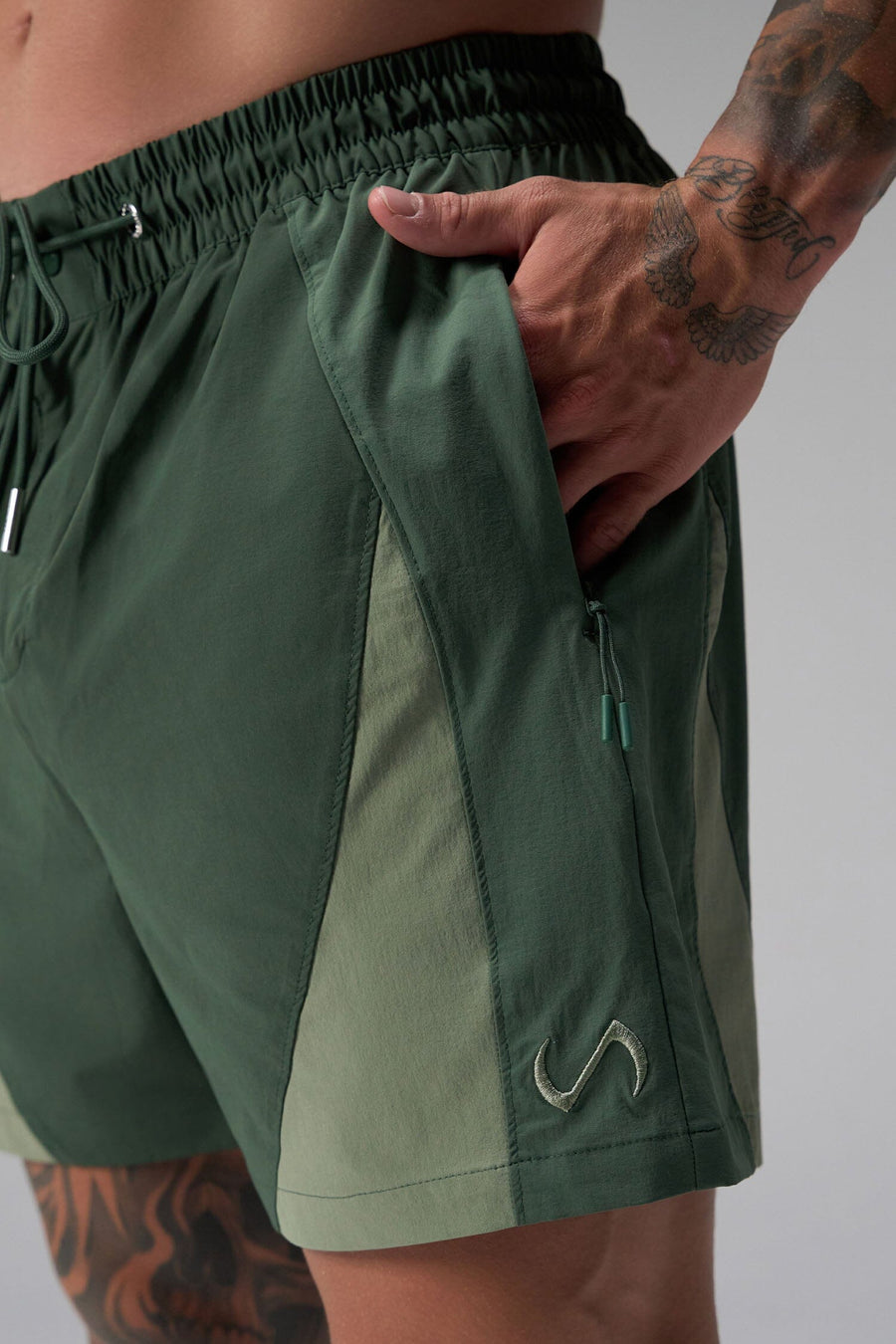 Front View of Green the TLF GTS Element-Max Shorts featuring contrast color panels and sleek invisible side zipper pockets
