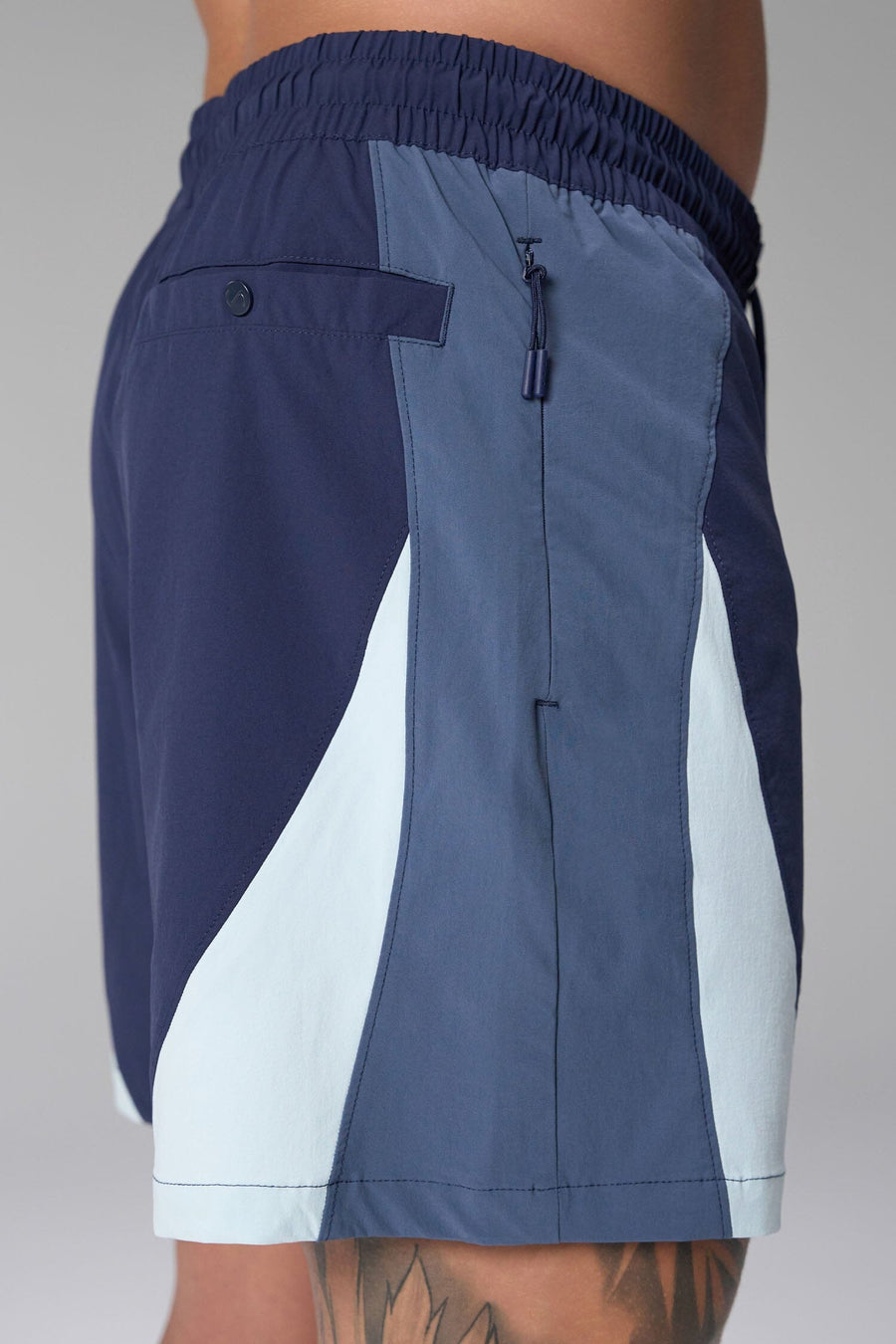 Side View of Blue the TLF GTS Element-Max Shorts featuring contrast color panels and sleek invisible side zipper pockets