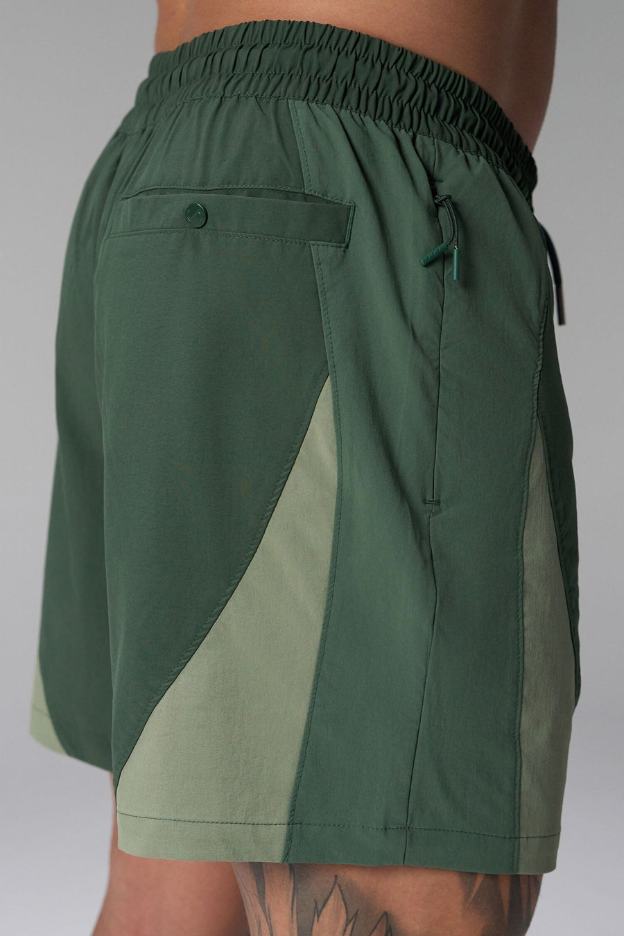 Side View of Green the TLF GTS Element-Max Shorts featuring contrast color panels and sleek invisible side zipper pockets