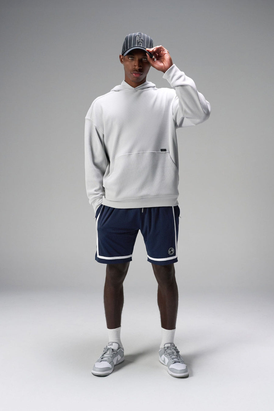 Front View of Blue GTS Athletic 8 Inch Shorts, featuring an 8-inch inseam and zipper pockets
