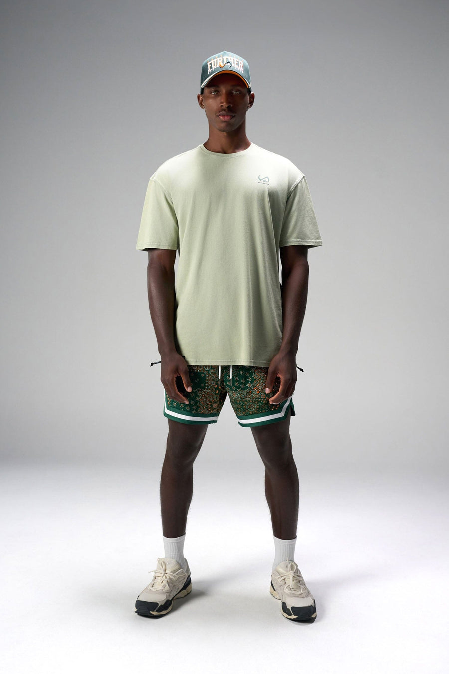 Front View of Green GTS Evolve Mesh 6 Inch Shorts, featuring university of Miami inspired patch paisley design and zipper pockets