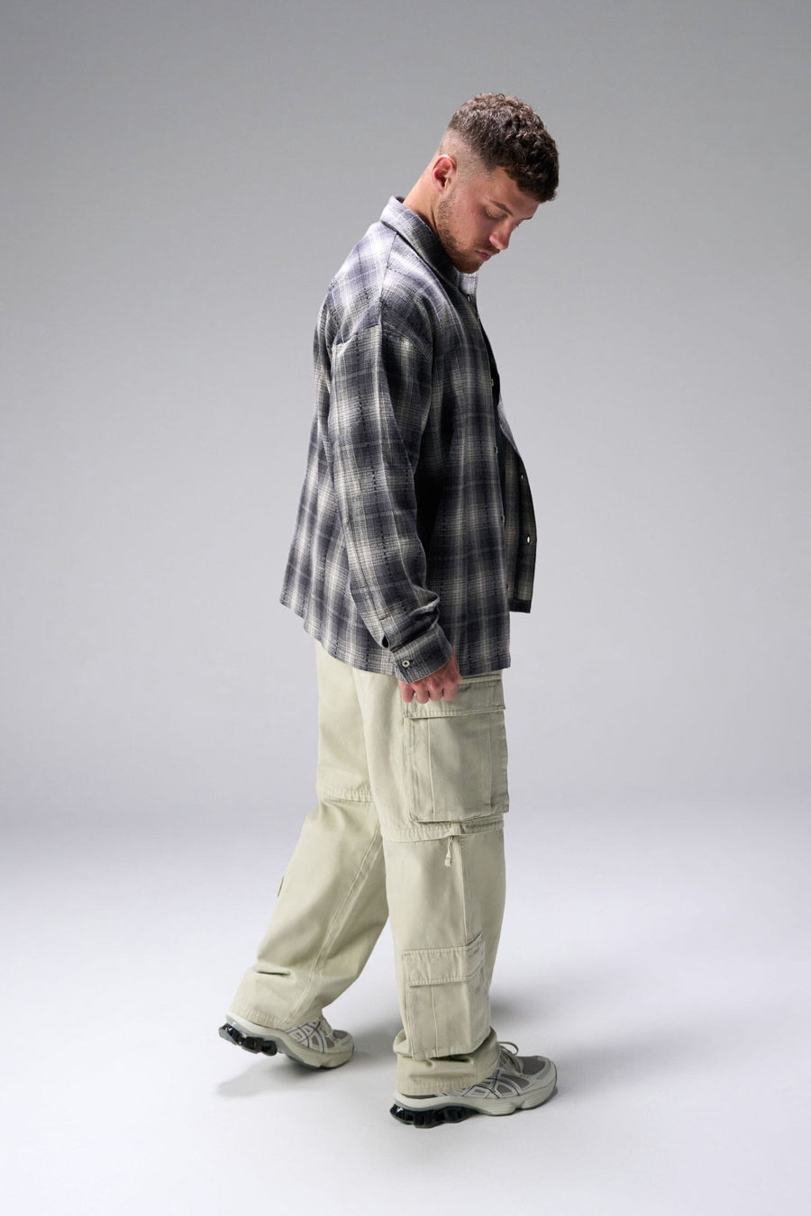 Side View of the Black TLF GTS Flannel Shacket crafted in premium cotton plaid flannel with elevated embroidery details on the collar and back