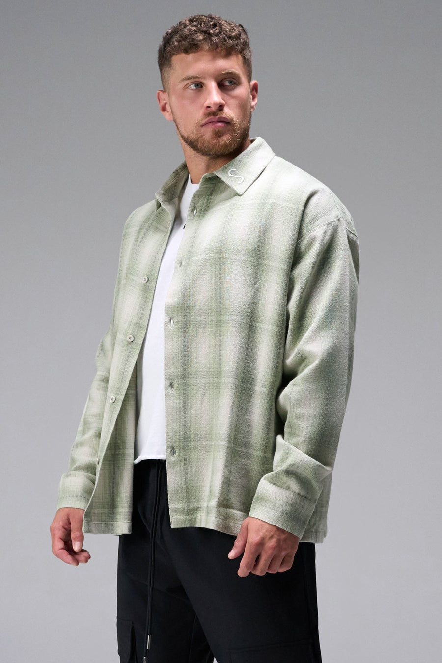 Front View of the Green TLF GTS Flannel Shacket crafted in premium cotton plaid flannel with elevated embroidery details on the collar and back