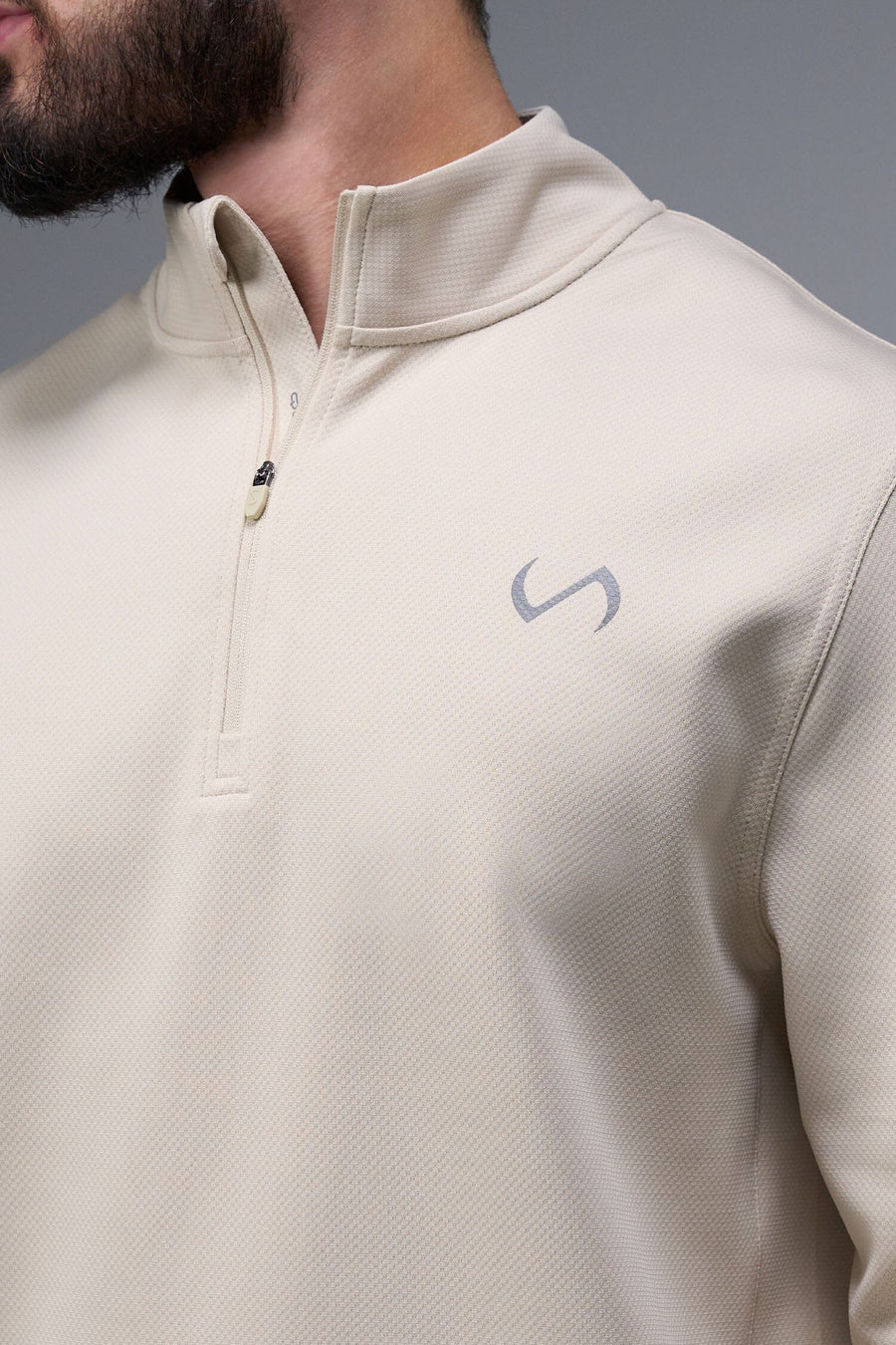 Detail Front View of Oat Milk TLF GTS Quad Tech Quarter-Zip Pullover redefining modern activewear, this men’s 1/4 zip pullover blends technology with sleek style