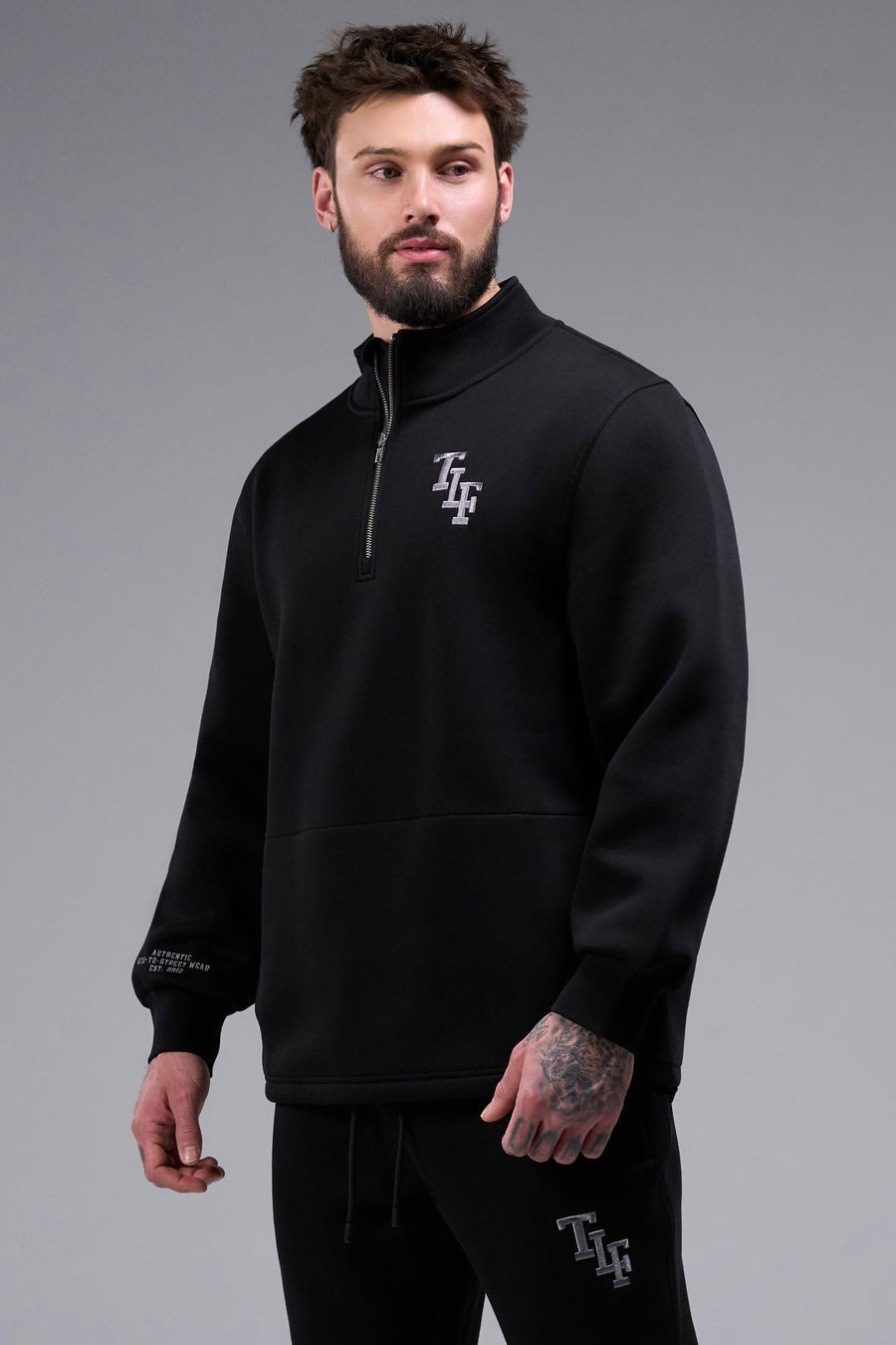 Front View of Black TLF GTS Scuba Tech Quarter-Zip Pullover, featuring a ¼ zip pullover, sleek design and kangaroo pockets