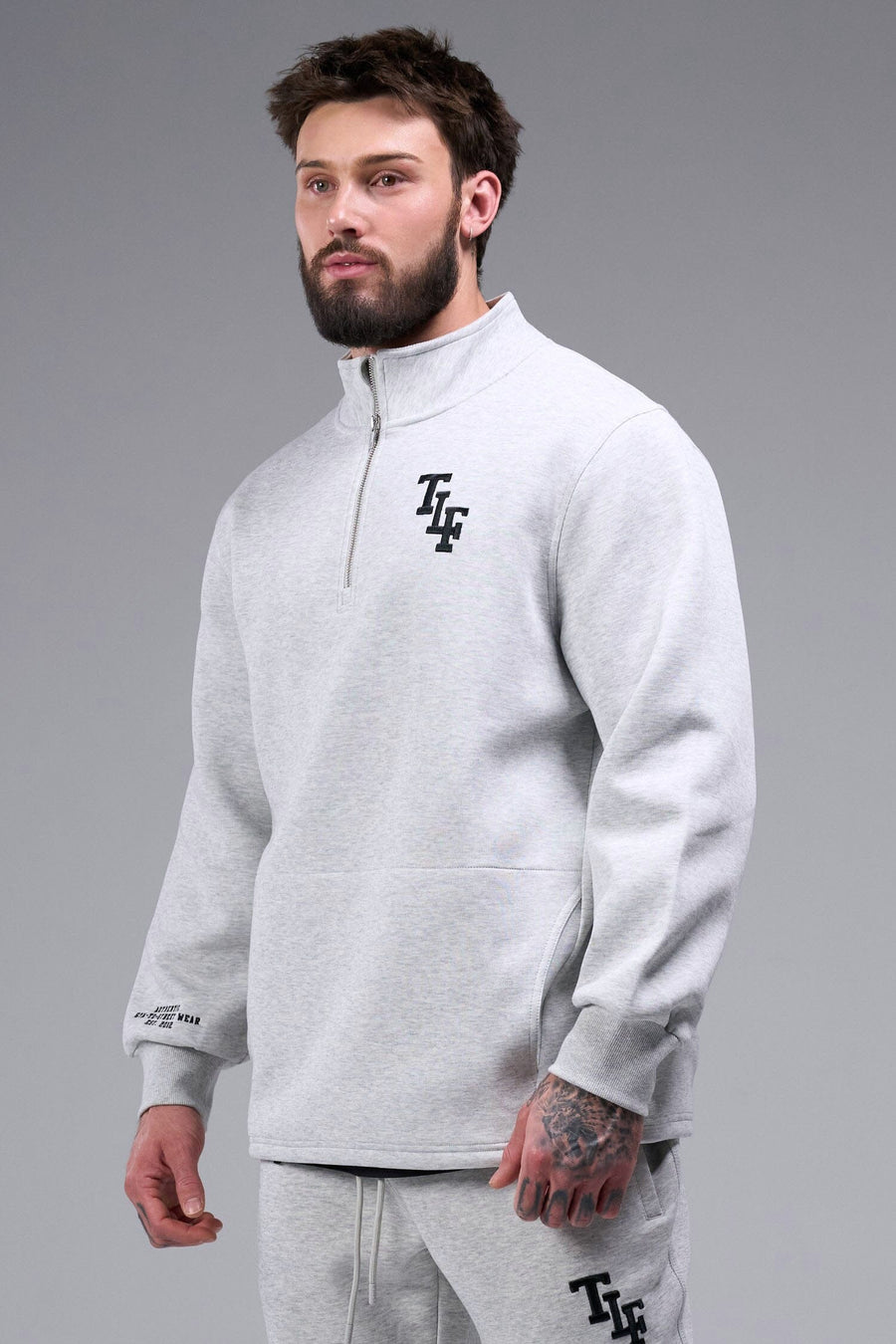 Front View of Light Heather Gray TLF GTS Scuba Tech Quarter-Zip Pullover, featuring a ¼ zip pullover, sleek design and kangaroo pockets