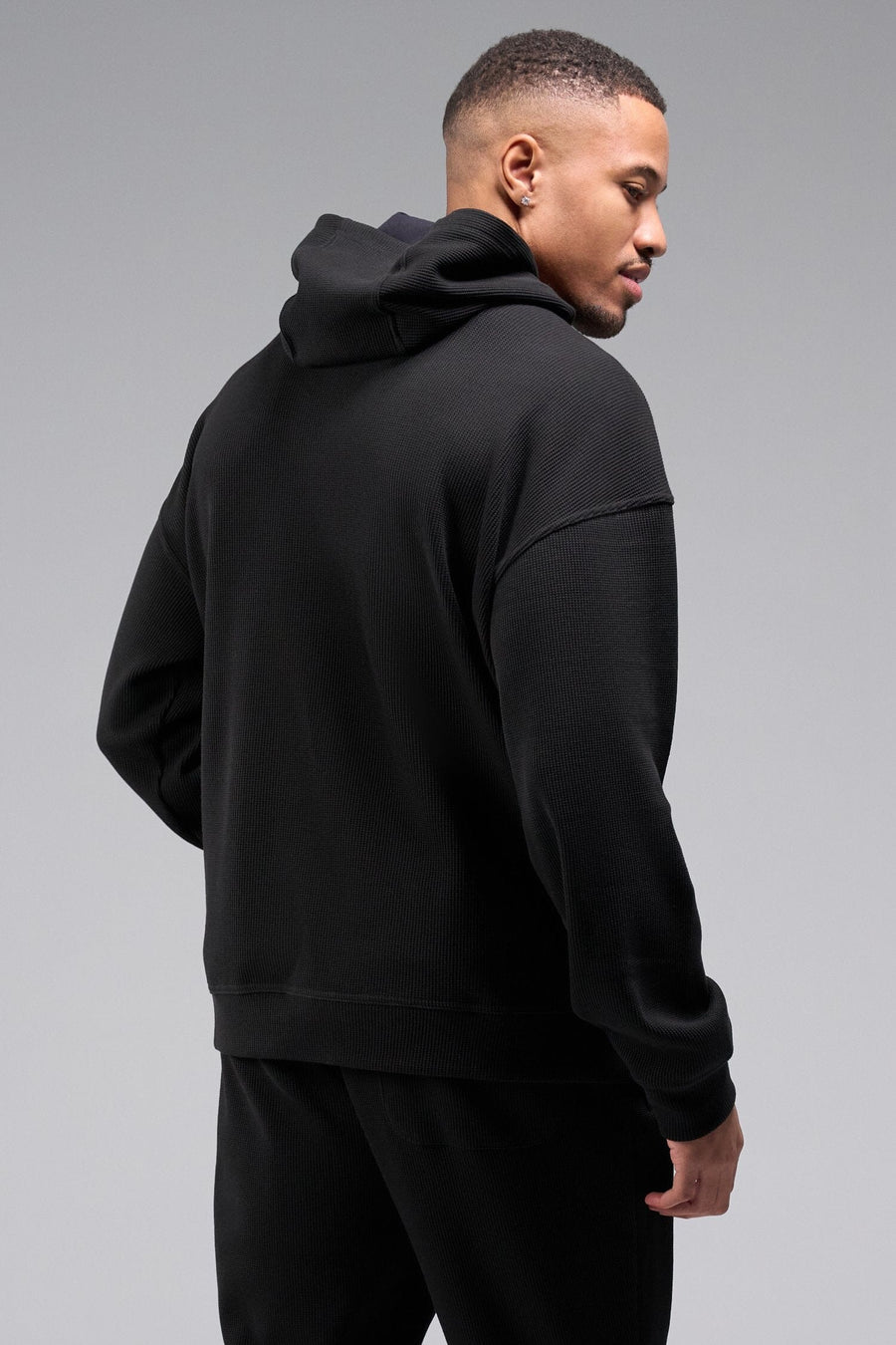 Back View of Black TLF GTS Waffle Tech Hoodie, featuring kangaroo pockets, and double panel hoodie designed for all day wear