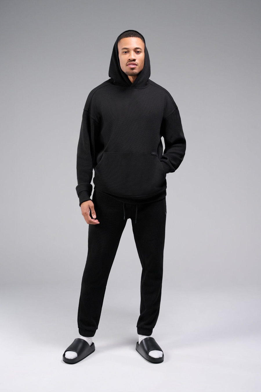 Front View of Black TLF GTS Waffle Tech Hoodie, featuring kangaroo pockets, and double panel hoodie designed for all day wear