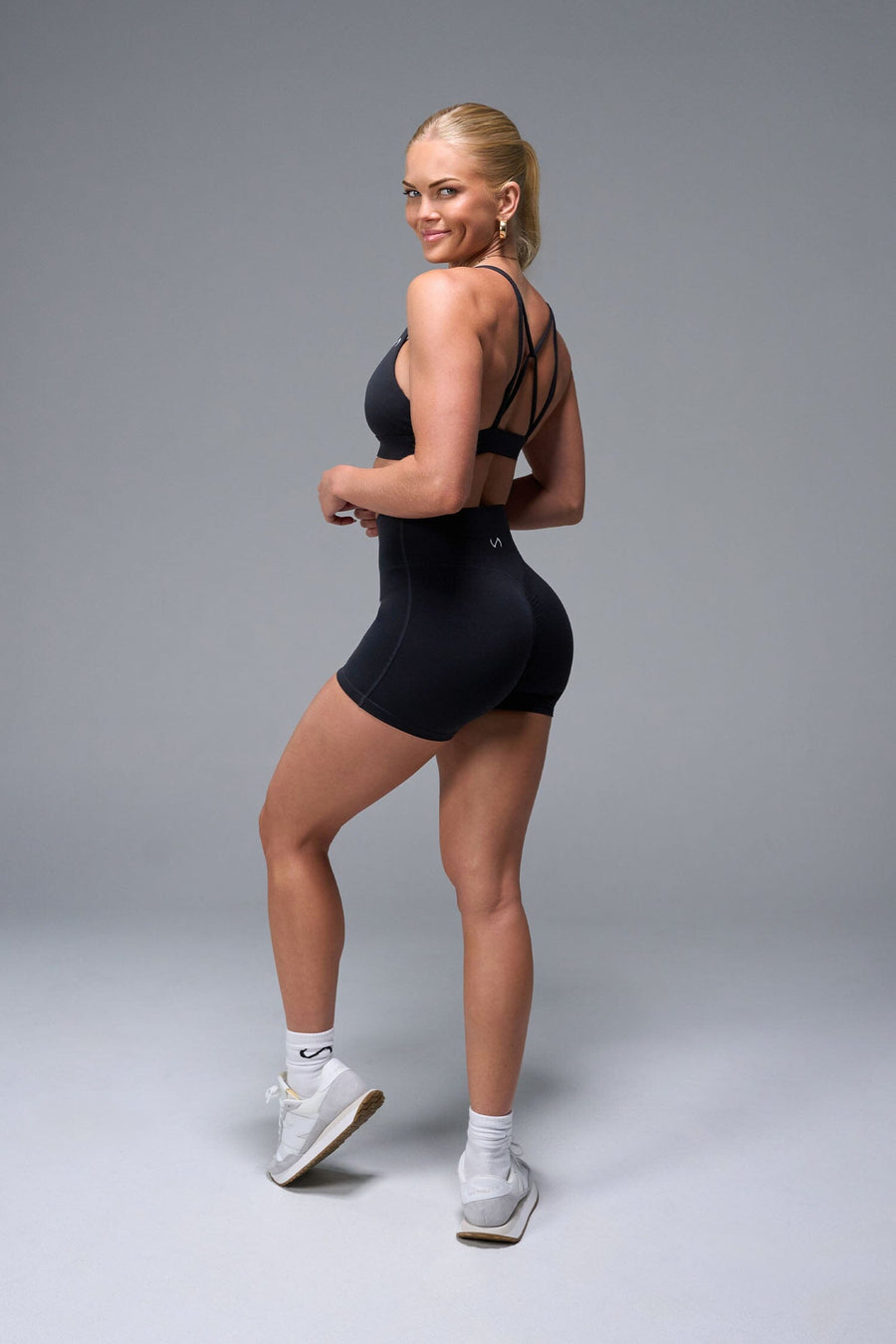 Back View of Black TLF NeoCloud™ 4 Inch Secret Glute Seam Shorts featuring our new secret glute seam technology to lift and shape your glutes.