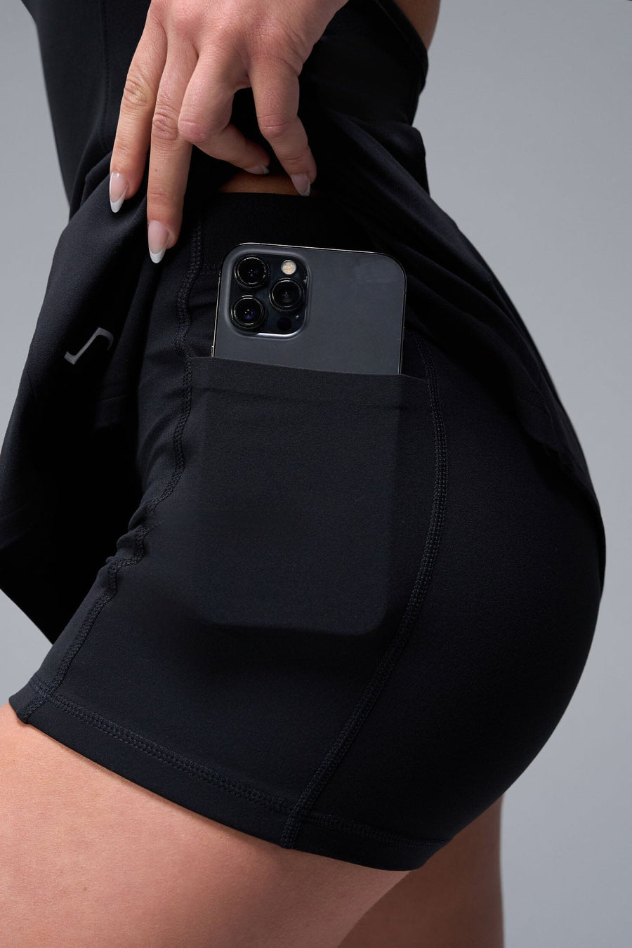 Front View of Black TLF NeoCloud™ Skort Dress featuring built in shorts with pockets, racerback design and built in sports bra with removable pads