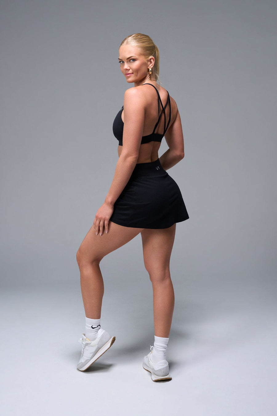 Side View of Black TLF NeoCloud™ workout skirt featuring built in 2.5-inch inseam shorts and side pockets