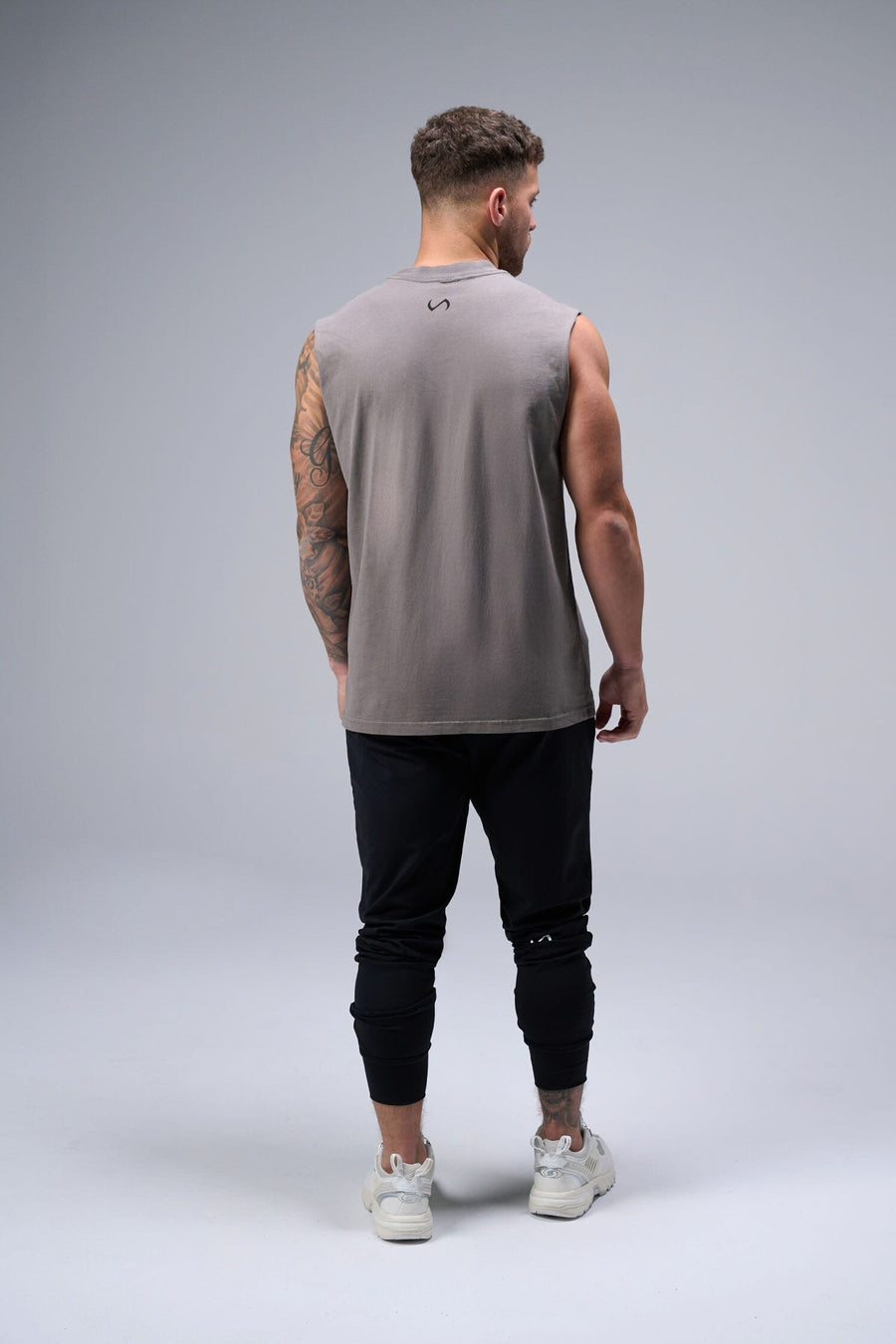 Back View of Gray TLF Property Of Heavy Cotton Muscle Tank featuring a distressed graphic design and raw edge arm holes.
