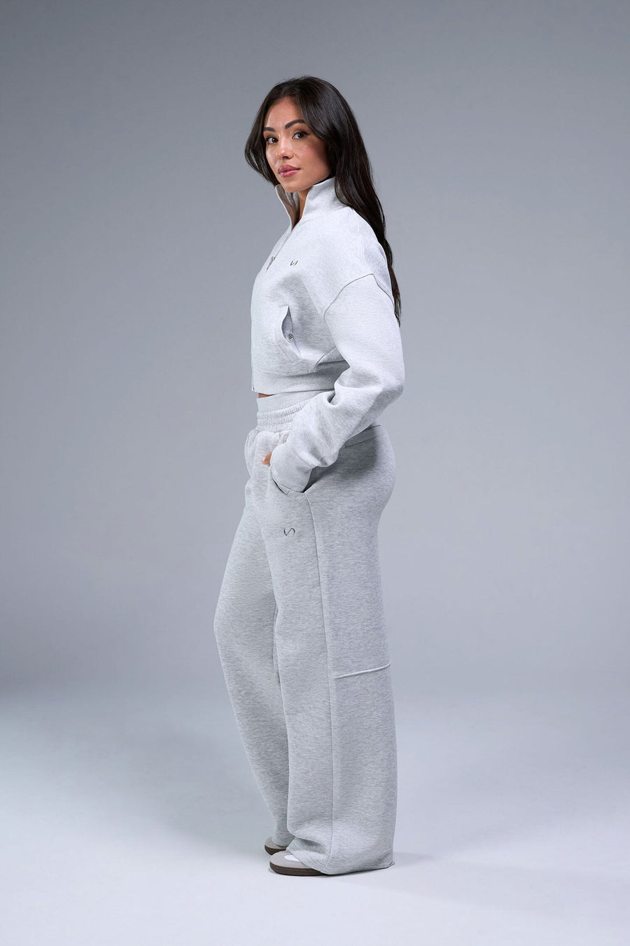Side View of Gray TLF Scuba Tech Cropped Zip Up Jacket, featuring side zipper pockets, thumbholes and a cropped length