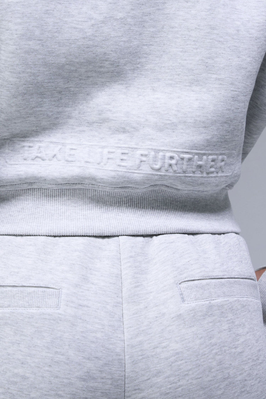 Back View of Gray TLF Scuba Tech Cropped Zip Up Jacket, featuring side zipper pockets, thumbholes and a cropped length