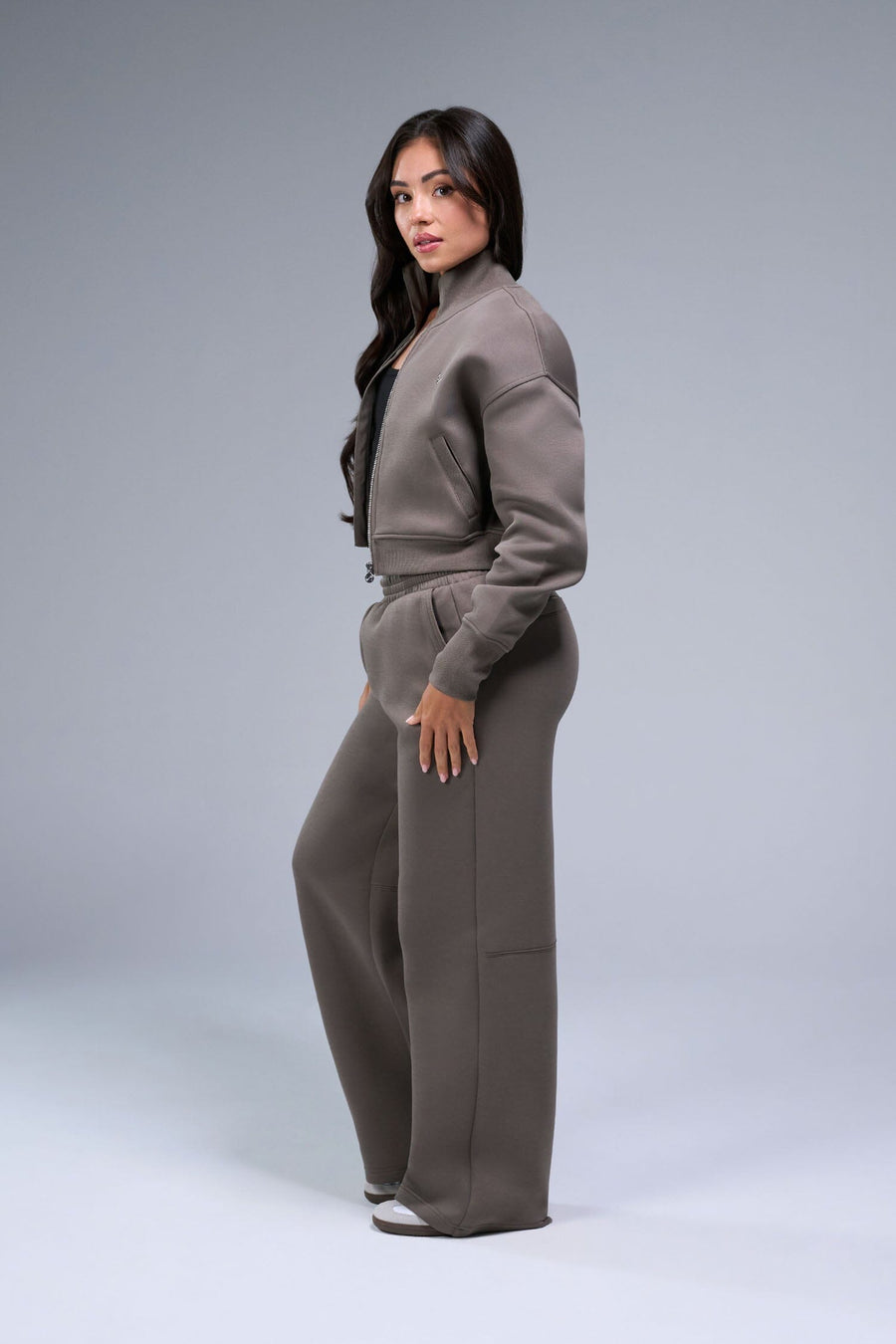 Side View of Brown TLF Scuba Tech Cropped Zip Up Jacket, featuring side zipper pockets, thumbholes and a cropped length