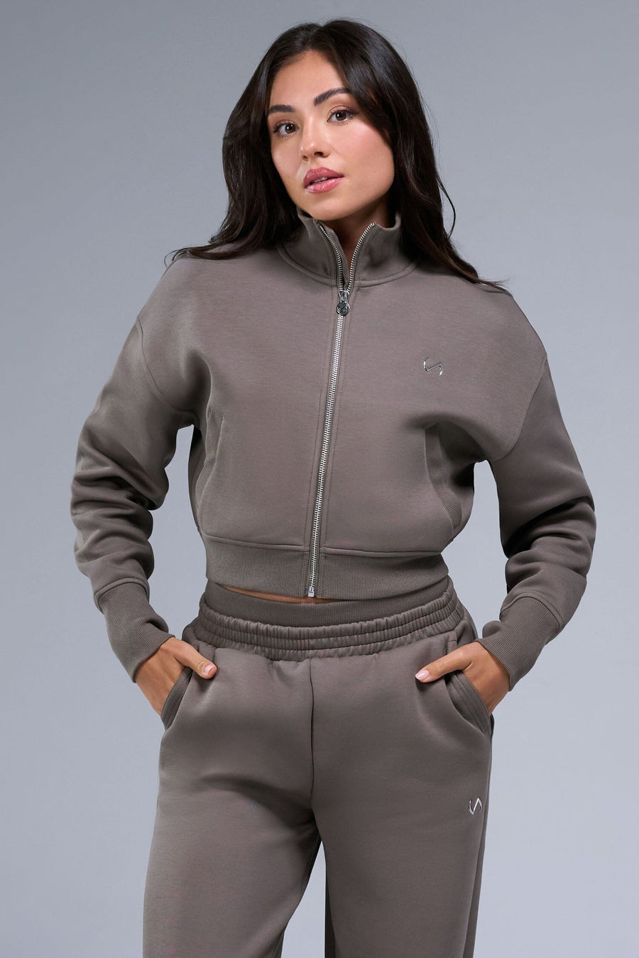 Front View of Brown TLF Scuba Tech Cropped Zip Up Jacket, featuring side zipper pockets, thumbholes and a cropped length