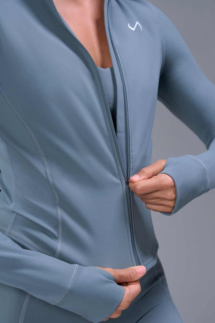 Front View of Blue TLF Tempo Cropped Zip Up Jacket featuring thumbholes and cropped length for gym and lifestyle wear