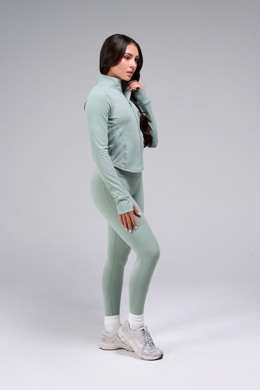 Side View Of Women's Tempo Cropped Zip Up Jacket in Sage Green