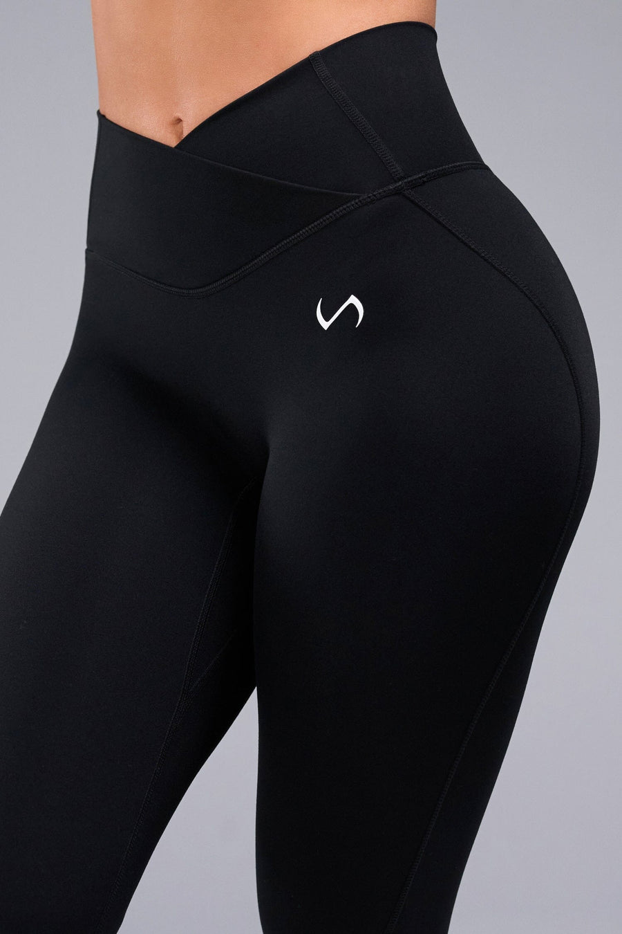 Front View of Black TLF Tempo Flare Leggings, featuring a waist snatching crossover waistband and glute shaping side seam