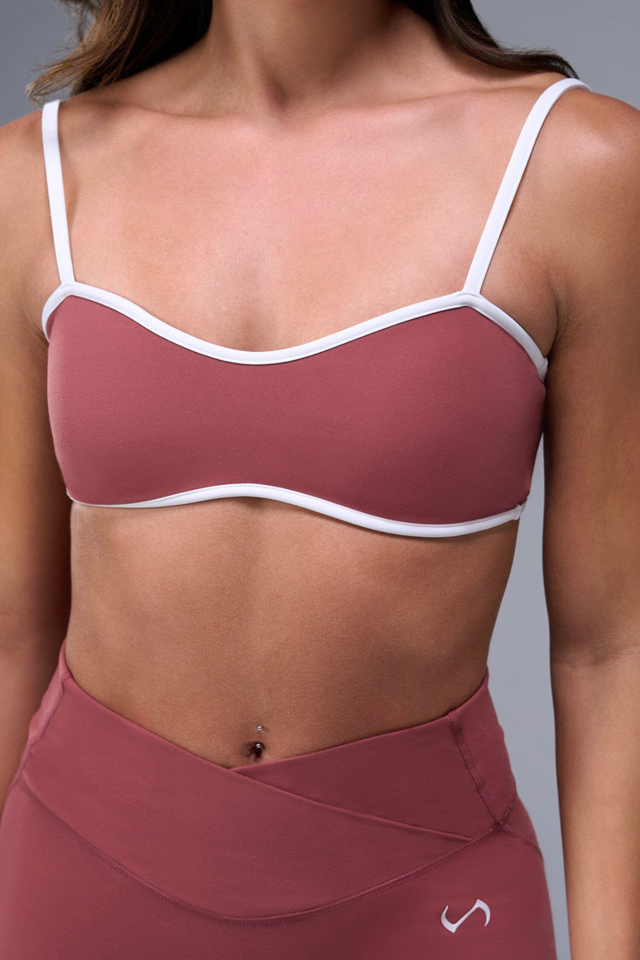 Front View of Orange Tempo Minimal Bralette 2.0, featuring removable pads and adjustable straps for low impact all day wear