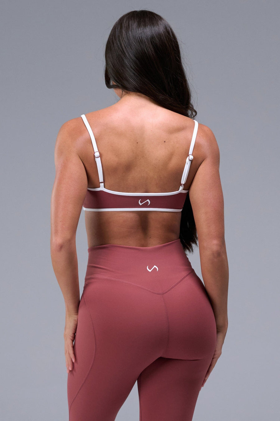 Back View of Orange Tempo Minimal Bralette 2.0, featuring removable pads and adjustable straps for low impact all day wear