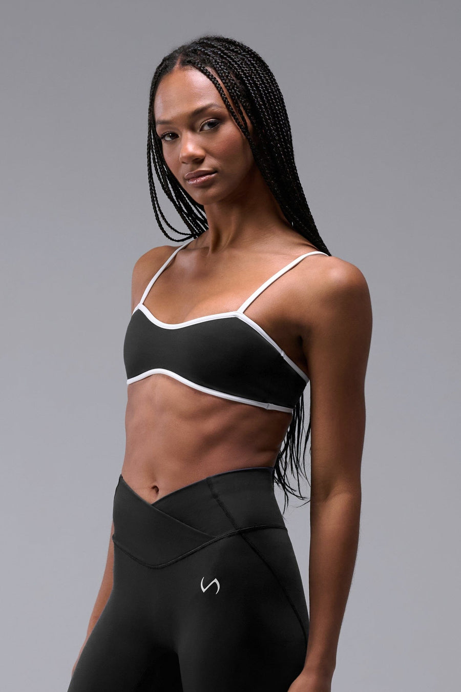 Front View of Black Tempo Minimal Bralette 2.0, featuring removable pads and adjustable straps for low impact all day wear