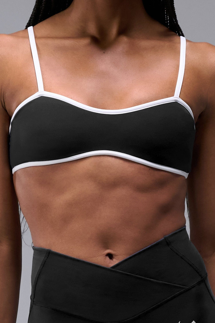 Front View of Black Tempo Minimal Bralette 2.0, featuring removable pads and adjustable straps for low impact all day wear