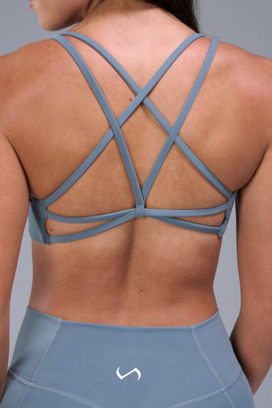 Back View of Blue TLF Tempo Strappy Back Sports Bra, featuring a minimal design for the gym and lifestyle wear