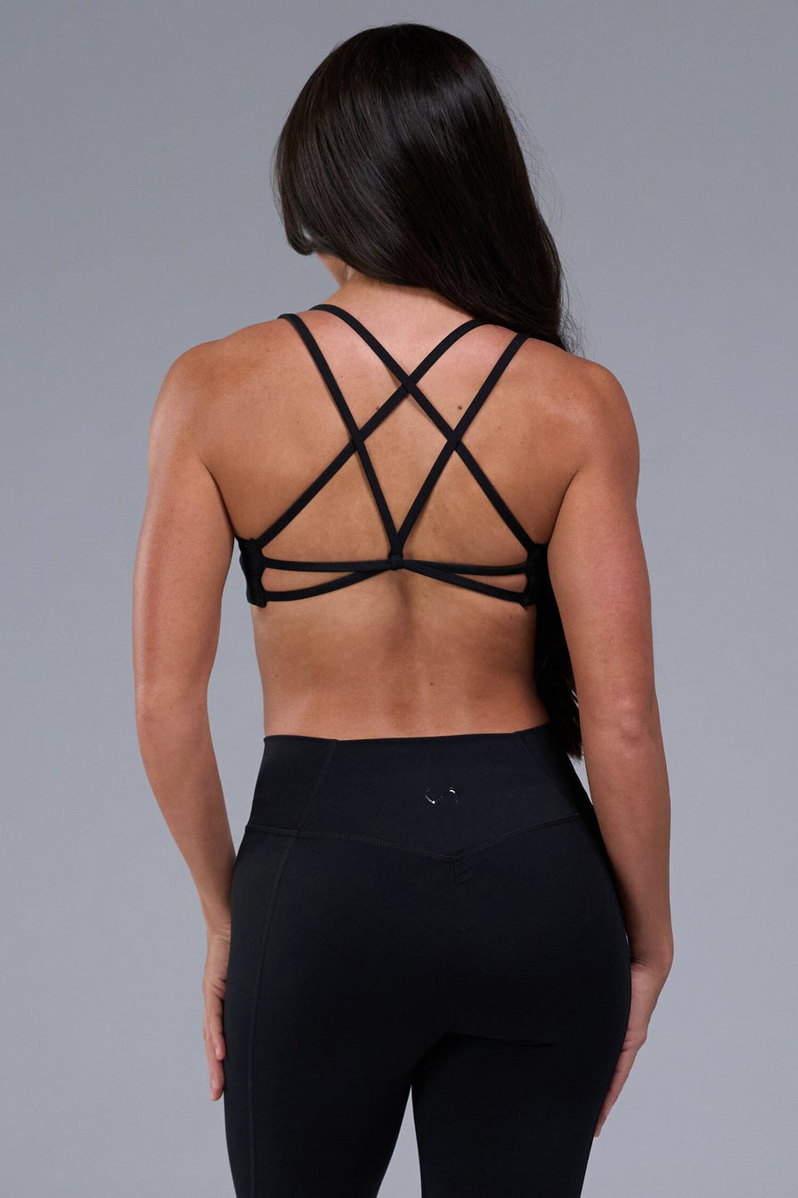 Back View of Black TLF Tempo Strappy Back Sports Bra, featuring a minimal design for the gym and lifestyle wear
