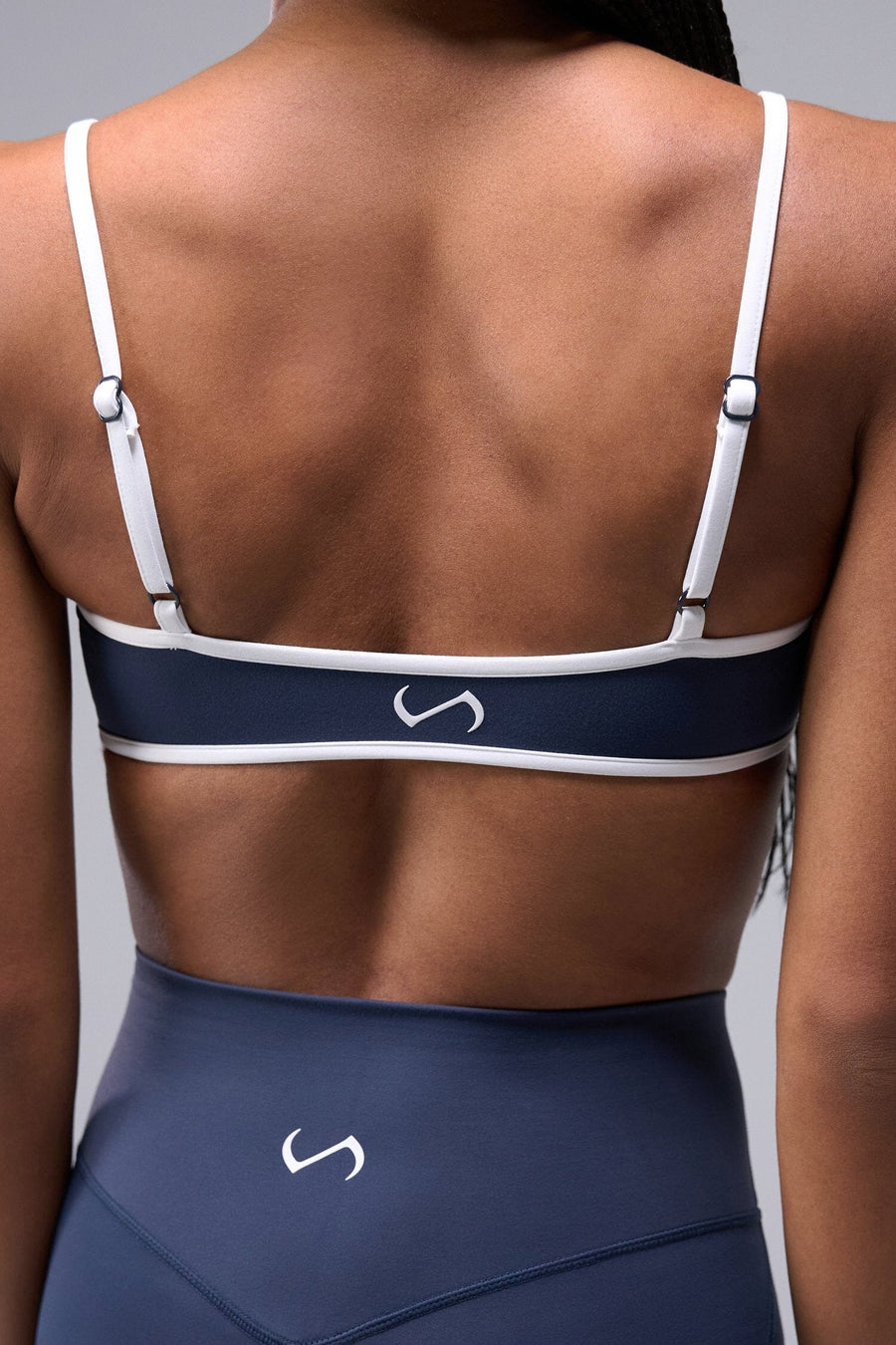Back View of Blue Tempo Minimal Bralette 2.0, featuring removable pads and adjustable straps for low impact all day wear
