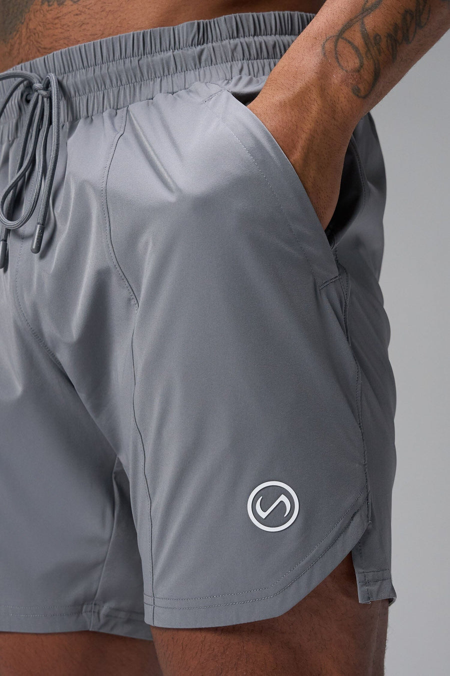 Detail View of Gray TLF Train Element 7 Inch Shorts featuring a 7 inch in seam and side zipper pockets designed for optimal performance