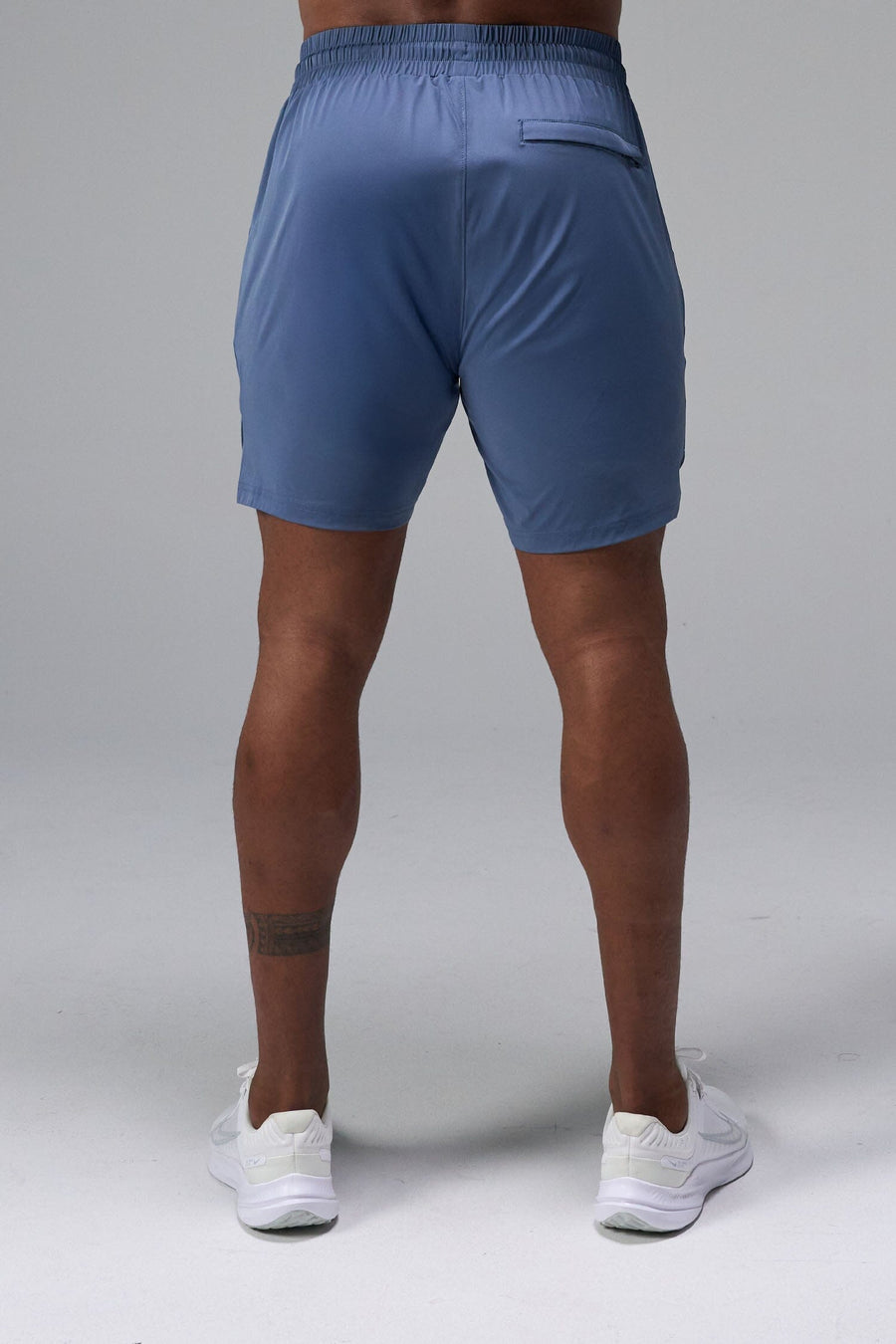 Back View of Blue TLF Train Element 7 Inch Shorts featuring a 7 inch in seam and side zipper pockets designed for optimal performance