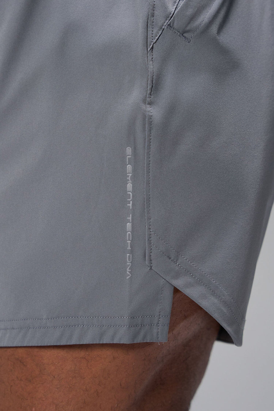 Detail Side View of Gray TLF Train Element 7 Inch Shorts featuring a 7 inch in seam and side zipper pockets designed for optimal performance