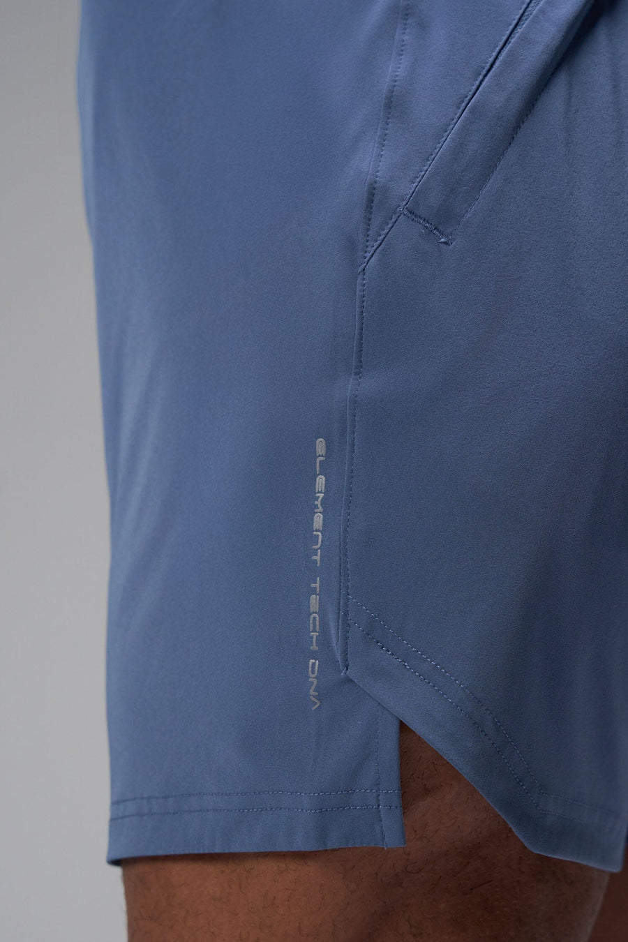 Detail Side View of Blue TLF Train Element 7 Inch Shorts featuring a 7 inch in seam and side zipper pockets designed for optimal performance